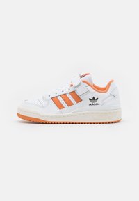 White leather sneaker with orange accents, featuring three orange stripes, a velcro strap, and a textured rubber sole.