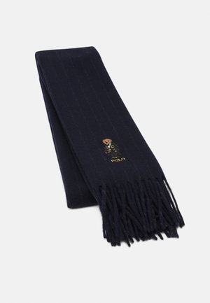 Écharpe bleu foncé à franges avec des rayures verticales et un logo brodé de l'ours Polo près d'une extrémité.