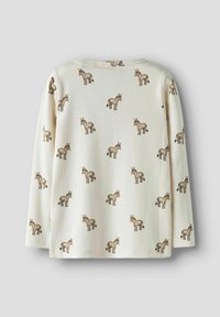 Kremowa bawełniana bluzka z długim rękawem z powtarzającym się brązowym nadrukiem osła. Posiada dekolt w serek i zaokrąglony dół. Miękka tekstura, luźny krój.