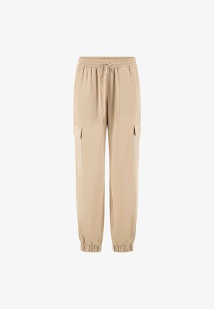 Beige cargo pants made of soft fabric, featuring elastic waistband, drawstring, and side pockets. Tapered leg with elastic cuffs.