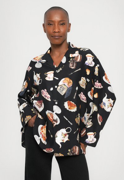 Black button-up shirt featuring colorful food and tea-themed prints, including cakes, teapots, and utensils, in a relaxed fit.