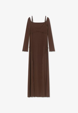 Long brown dress with thin shoulder straps, long sleeves, scoop neckline, and decorative wavy seams on a white background.