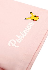 Pink cotton fabric featuring a Pikachu graphic with a smiling face and black, yellow, and red accents, alongside the word "Pokémon" in white.