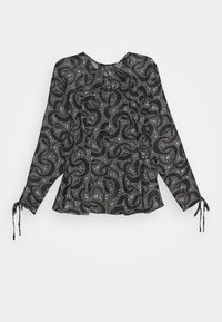 Blouse noire à manches longues, ornée d'un motif de points blancs en tourbillons. Liens aux poignets, design péplum et encolure arrondie.