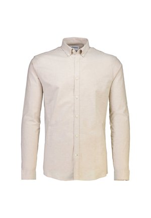 Chemise à manches longues beige clair, en tissu doux et texturé, avec un col classique et une patte de boutonnage à l'avant. Design minimaliste.