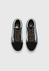 Denim sneakers with brown laces, black toe cap, and white accent stripe. Features a round shape and soft textile upper.