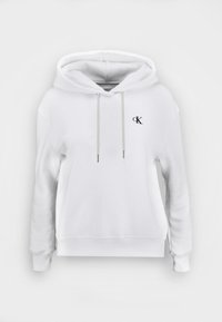 White hoodie made of soft fabric, featuring a drawstring hood, elastic cuffs, and a small black logo on the chest.