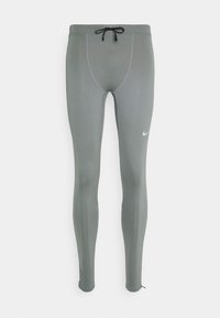 Leggings gris Nike au design ajusté, avec une taille élastique, un cordon de serrage et des détails de couture subtils. Présente un petit logo sur la jambe gauche.