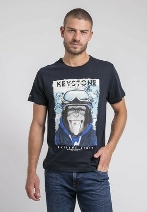 T-shirt en coton noir avec un graphisme d'un gorille portant des lunettes de ski et un hoodie bleu, avec le texte "KEYSTONE COLORADO" et "EXTREME LIMIT".