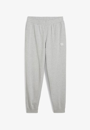 Šedé teplákové nohavice vyrobené z mäkkej tkaniny, s elastickým pásom, manžetami na členkoch a malou nášivkou loga na ľavom stehne.