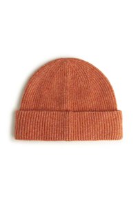 Bonnet en tricot dans un orange atténué avec une texture côtelée. Présente une bordure repliée et des variations subtiles de couleur pour plus de profondeur. Matière douce semblable à la laine.