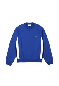 Niebieska bluza z białymi i granatowymi panelami bocznymi, ściągaczami przy rękawach oraz okrągłym dekoltem. Posiada małe zielone logo na piersi. Miękka tekstura materiału.