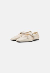 Beige flats with a pointed toe, featuring a mesh design and a buckle strap. Soft material, flat sole, and textured accents.