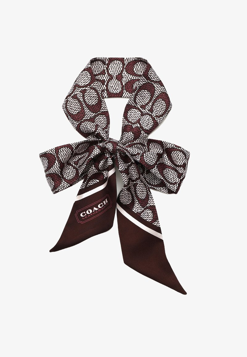 Foulard di seta in bordeaux scuro e bianco, caratterizzato da un motivo astratto. Include un'etichetta con il logo "COACH" in un design rettangolare.