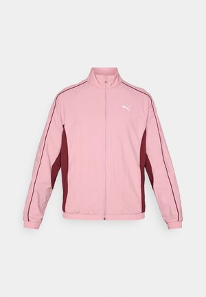 Lyserosa zip-up jakke med maroon siden paneler og hvit logo. Laget av et glatt, lett materiale med ribbestrikkede mansjetter.