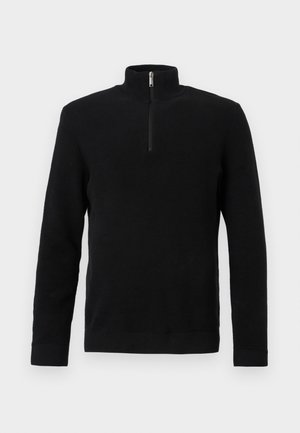 Fekete, hosszú ujjú, texturált pulóver, fél cipzáros magas gallérral, bordás mandzsettákkal és szegéllyel, fehér háttéren bemutatva.