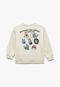 Sudadera color crema presenta diversas ilustraciones de animales y un texto divertido que dice "todos los amigos se quedan juntos y se divierten" en negro y azul.
