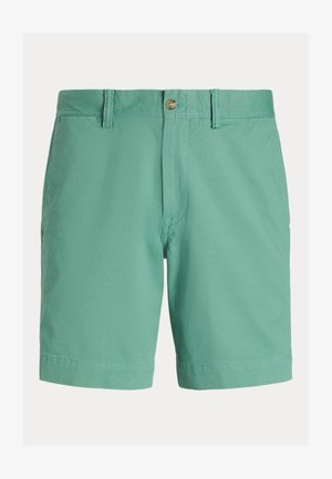 Męskie spodenki w jasnym zielonym kolorze, wykonane z mieszanki bawełny. Posiadają płaską przednią część, zapięcie na guzik, szlufki na pasek oraz boczne kieszenie. Gładka tekstura.