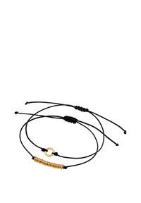 Sort snorarmbånd med en spiralformet guldaccent og en cirkelformet guldspænde. Justerbart med knyttede ender for en personlig pasform.