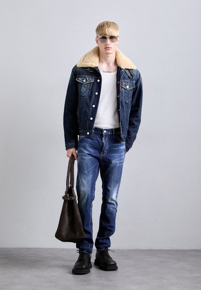Denim jacket with a beige shearling collar, white t-shirt, blue jeans, black shoes, and a brown leather bag. Casual design with classic detailing.