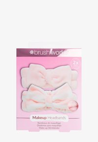 Twee zachte, pluche make-up haarbanden in pastelroze, met grote strikken, verpakt in een roze doos met het label "Makeup Headbands."