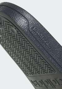 Dark blue rubber outsole with textured pattern and branded "cloudfoam" detail; features a herringbone grip design for traction.