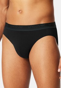 Black cotton briefs with a textured diamond pattern and a broad black waistband featuring the word "uncover" in dark lettering.