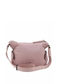 Light pink fabric shoulder bag with a zippered closure, adjustable strap, and a rectangular logo patch. Smooth texture and rounded shape.