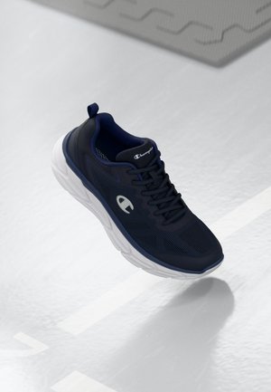 Navy athletic shoe with a mesh upper and white sole. Features a textured design, laces, and a logo on the side and heel tab.