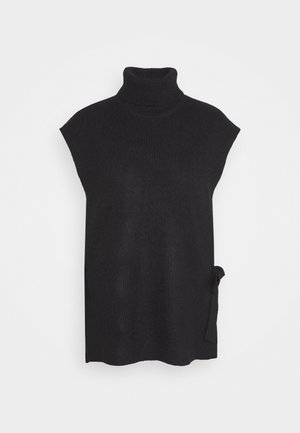 Pull sans manches noir en maille à col roulé avec détail de lien sur le côté et coupe ample sur fond gris clair uni.