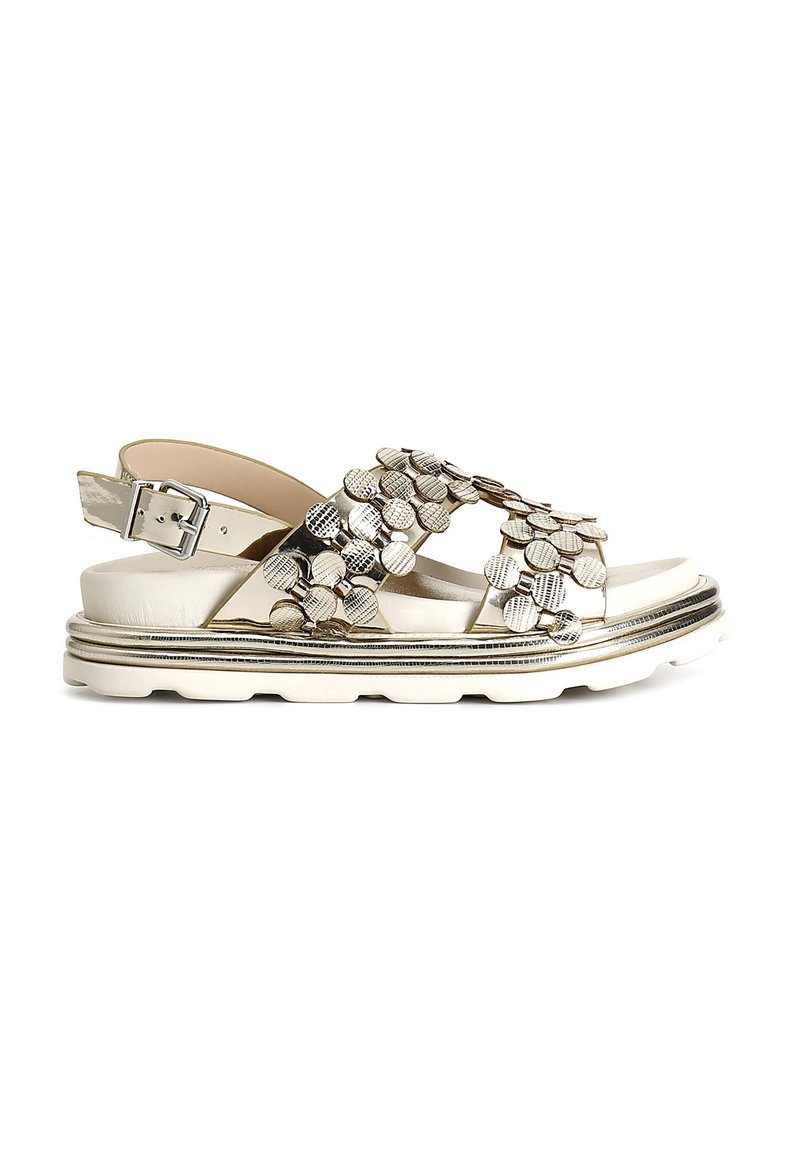 Metallic silver sandals with textured circular embellishments, an adjustable ankle strap, and a white platform sole with a decorative trim.