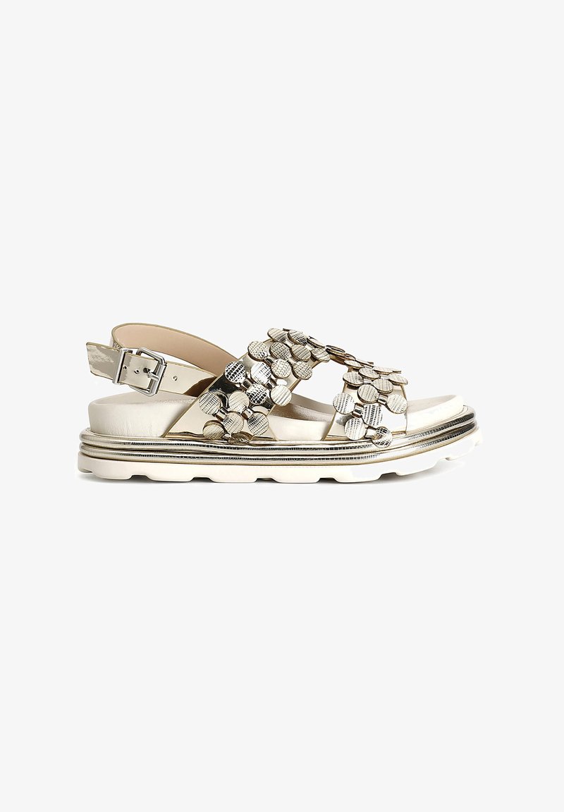 Metallic silver sandals with textured circular embellishments, an adjustable ankle strap, and a white platform sole with a decorative trim.