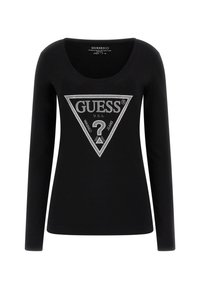 Mustaharma pitkähihaine t-paita, jossa on pyöreä kaula-aukko. Sisältää suuren hopean kolmion graafisen kuvion, jossa lukee "GUESS U.S.A" ja kysymysmerkki keskellä.