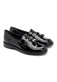 Black patent leather loafers featuring a flat sole, decorative tassels, and metal accents. Classic rounded toe and smooth finish.