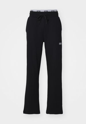 Pantaloni della tuta neri realizzati in tessuto morbido, con vita regolabile tramite cordino e gambali svasati. Presenta un piccolo logo sul lato.