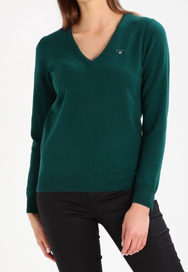 Green v-neck sweater made of soft material, featuring long sleeves and ribbed hem. Small logo detail on the chest.