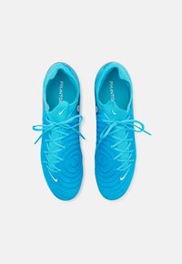 Scarpe da ginnastica blu brillante con tomaia testurizzata, sistema di allacciatura rotondo e logo bianco iconico. Design leggero, adatto per vari sport.