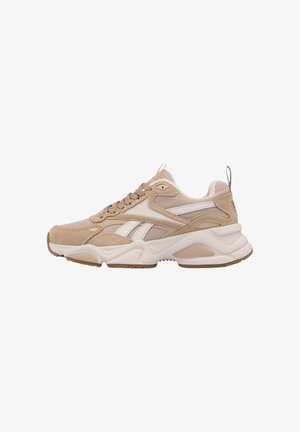 Beige and white athletic sneaker with mesh and suede panels, thick cushioned sole, lace-up design, and pull tab at heel.