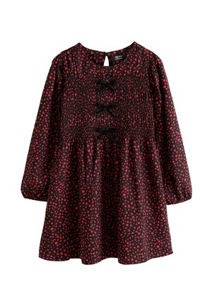 Black long-sleeve dress with red heart patterns, elastic smocked bodice, and three black bow decorations down the front.
