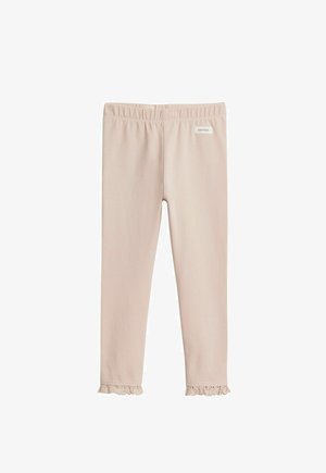 Lichtbeige peuterlegging met elastische tailleband, kanten ruches aan de enkels en een klein label met "newbie" vlakbij de taille.