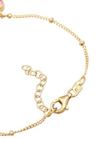 Guldkedjearmband med hummerlås, sammanlänkade länkar och en slät yta med minimalistiska designelement.