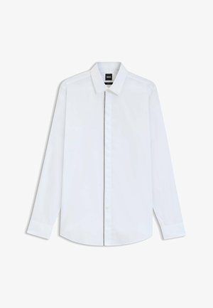 Camisa blanca de manga larga hecha de algodón suave. Cuenta con un collar clásico, cierre de botones y puños ajustados. Diseño minimalista, sin patrones.