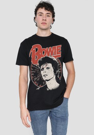 Black cotton t-shirt featuring a retro print of David Bowie, with red accents and a circular design around the graphic.