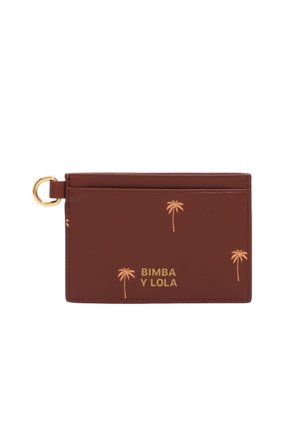 Tarjetero marrón con estampados dorados de palmeras, anilla para llaves dorada a la izquierda y el logo "BIMBA Y LOLA" en texto dorado en el frente.