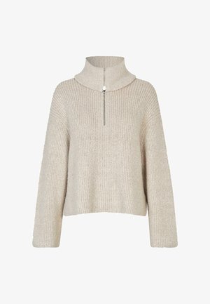 Beige kötött pulóver magas gallérral és fél cipzárral. Bordás textúrával és széles ujjal rendelkezik. Rövidített fazon.