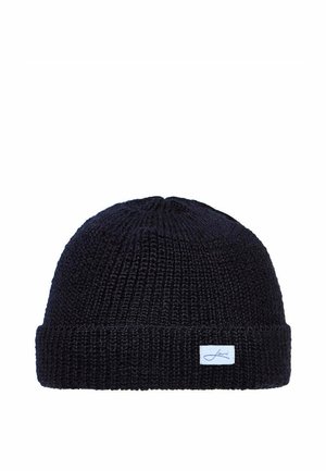 Black knitted beanie hat with folded cuff and small rectangular white label on the front.