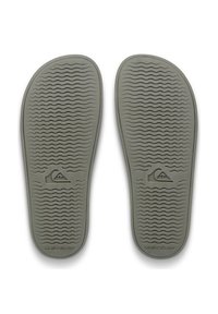 Οι γκρι λαστιχένιες εσωτερικές σόλες διαθέτουν κυματιστή υφή για πρόσφυση, το λογότυπο Quiksilver και τριγωνικό σχέδιο στη φτέρνα. Ομαλή επιφάνεια συνολικά.