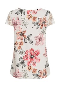 Korte mouwen top met bloemenprint in crème, met roze en grijze bloemen, voorzien van kanten accenten op de mouwen en een gebogen zoom voor een comfortabele pasvorm.