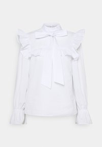Blusa bianca a maniche lunghe con dettagli arricciati sulle spalle e sui polsini, colletto alto e un grande fiocco al collo. Tessuto dalla texture morbida.