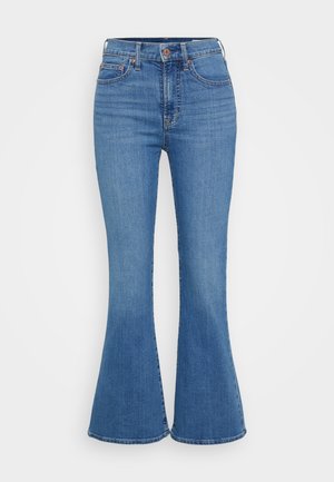 Lyseblå klokkeformede jeans med høj talje, lavet af denim. Funktionen inkluderer to forlommer og en knaplukning i taljen.